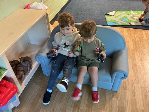 Preschool children forming connections on the couch together