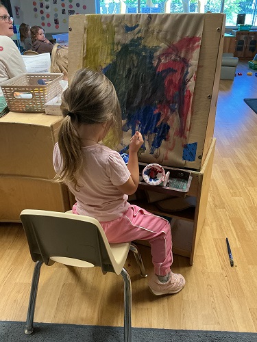 Child painting in the preschool room