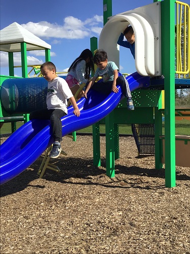 Children sliding down the slide