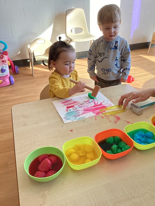 Children dipping wands into bubble solution