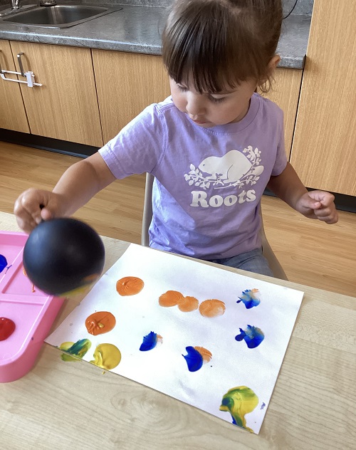 A preschool child making balloon art