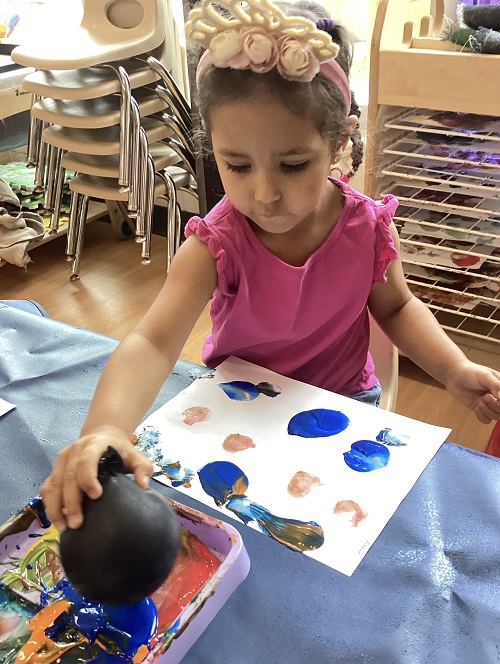 A preschool child making balloon art