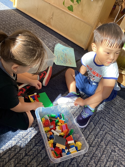 children playing with lego blocks