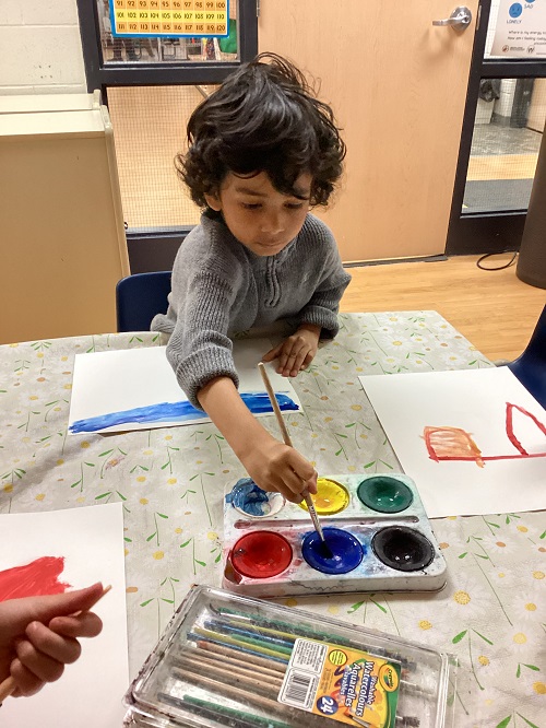 child getting creative with paint