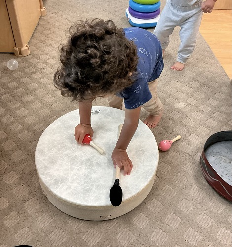 Infant child exploring with drums