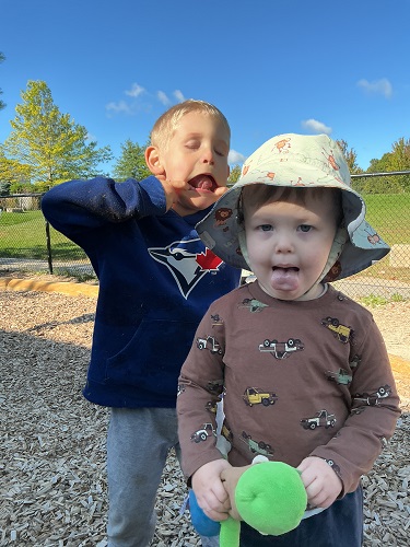 Two preschool children exploring facial expressions