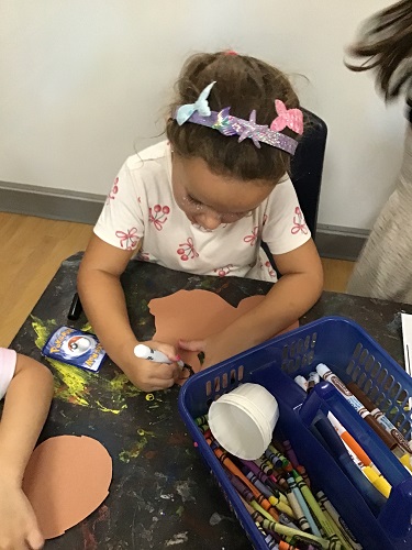 School aged child exploring with art materials