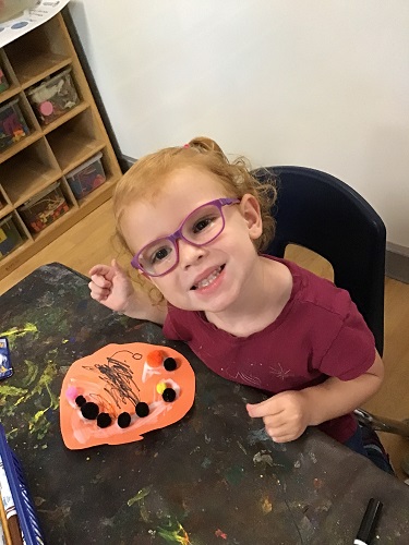 School aged child exploring with art materials